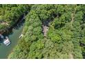 Aerial view of a lakeside home surrounded by mature trees, providing privacy at 188 Stonemarker Rd, Mooresville, NC 28117