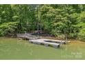 View of a well-maintained private dock on the lake, perfect for boating and swimming at 188 Stonemarker Rd, Mooresville, NC 28117