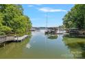 Picturesque view of the lake with docks and boat houses at 188 Stonemarker Rd, Mooresville, NC 28117