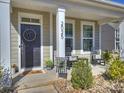 Inviting front porch featuring a welcoming wreath, rocking chairs and fresh spring plants at 2025 Sweet Magnolia Ln, Clover, SC 29710