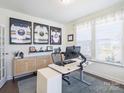 Bright home office featuring a modern stand-up desk, ample storage, and sporty decor at 2025 Sweet Magnolia Ln, Clover, SC 29710