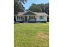 Charming one-story home with a welcoming front porch and a well-manicured lawn at 203 Blanche Ave, Belmont, NC 28012
