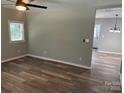 Open-concept floor plan featuring wood-look floors and stylish light fixture at 203 Blanche Ave, Belmont, NC 28012