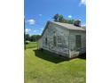 Side view of home with peeling paint and some greenery, needing some TLC at 204 13Th St, Belmont, NC 28012