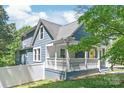 Charming two-story blue home with a welcoming front porch and fenced yard at 219 Lee St, Fort Mill, SC 29715