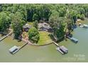 An aerial view of the lakeside property with multiple docks and lush green surroundings at 230 Shady Cove Rd, Troutman, NC 28166