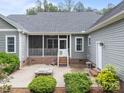Backyard patio with screened in porch and stone fire pit at 230 Shag Bark Ln, Salisbury, NC 28146