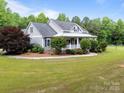 Well-maintained home with manicured landscaping and a sprawling green lawn at 230 Shag Bark Ln, Salisbury, NC 28146