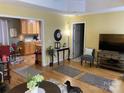 Open living room with hardwood floors flowing into the kitchen at 2339 Wednesbury Ct, Kannapolis, NC 28083