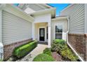 Charming home featuring a well-manicured front yard and a welcoming black front door at 28129 Song Sparrow Ln, Fort Mill, SC 29707