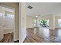 Bright living room with wood floors, ceiling fan, and sliding glass doors to the balcony at 28129 Song Sparrow Ln, Fort Mill, SC 29707