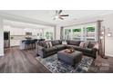 Open-concept living room seamlessly connects to the kitchen with contemporary decor and lots of natural light at 3218 Gilroy Dr, Fort Mill, SC 29707
