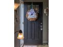 Close up of the front door with a decorative 'Welcome' wreath, making a warm first impression at 386 Greenlea Cir, Taylorsville, NC 28681