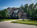 Lovely home featuring a brick exterior, well-manicured lawn, and an attached two-car garage at 4006 Tremont Dr, Indian Trail, NC 28079