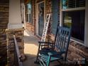 Inviting front porch with rocking chair and charming decor, showcasing a warm and welcoming entrance at 4006 Tremont Dr, Indian Trail, NC 28079
