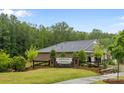 Entrance to Heron Creek community with lush green landscape and stone monument at 4008 Leyland Ct, Charlotte, NC 28227