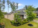 Well-manicured lawn and landscaping highlight this home's brick and stone facade at 4008 Leyland Ct, Charlotte, NC 28227