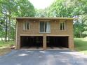 Spacious two-car garage with brick exterior and ample parking space at 4476 Nc Hwy 200 Rd, Stanfield, NC 28163