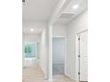 Bright hallway with neutral walls, hardwood floors, and doors leading to various rooms at 4619 Harris Elliot Rd, Lincolnton, NC 28092
