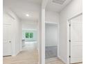Bright hallway with neutral walls, hardwood floors, and doors leading to various rooms at 4619 Harris Elliot Rd, Lincolnton, NC 28092