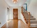 Welcoming foyer featuring hardwood floors, staircase, and natural light at 5108 Tedorill Ln, Charlotte, NC 28226
