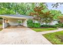 Attached carport offers covered parking and complements the home's light-colored exterior and landscaping at 5162 Lincrest Pl, Charlotte, NC 28211