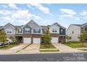 Street view of well-maintained townhomes with attractive brick and siding exteriors at 6011 Chelsea Oaks Rdg, Tega Cay, SC 29708