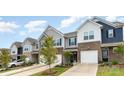 Lovely townhome with brick accents, a one car garage, and professionally landscaped front yard at 6011 Chelsea Oaks Rdg, Tega Cay, SC 29708