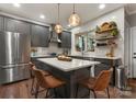 Stylish kitchen with a large island, stainless steel appliances, and modern pendant lights at 611 Meadow Lake Dr, Matthews, NC 28105