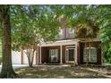 Inviting brick home with a covered front porch and meticulously kept landscaping at 8221 Brookings Dr, Charlotte, NC 28269