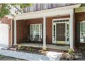Welcoming front porch with seating and beautiful landscaping, offering a cozy curb appeal at 8221 Brookings Dr, Charlotte, NC 28269