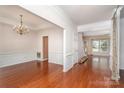 Bright, open-concept living space with hardwood floors and elegant wainscoting at 8221 Brookings Dr, Charlotte, NC 28269