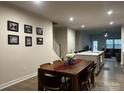Open concept dining area with wood table, stylish seating, and seamless access to kitchen and living spaces at 934 Prince Garrett Way, Denver, NC 28037