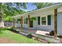 Inviting front porch with wooden columns and hanging flower baskets at 983 Willowbrook Ave, Rock Hill, SC 29730