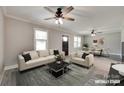 Staged living room and dining room featuring modern furnishings and updated lighting at 983 Willowbrook Ave, Rock Hill, SC 29730