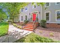 Beautiful home exterior showcasing brick stairs leading to a bright red front door at 10338 Hollybrook Dr, Charlotte, NC 28277