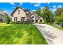 Brick home featuring well-maintained landscaping, a large driveway, and a three-car garage at 107 Blue Ridge Trl, Mooresville, NC 28117
