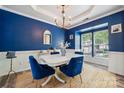 Cozy dining room with blue walls, gold accents, and bright natural light at 108 N Arcadian Way, Mooresville, NC 28117