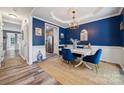 Formal dining room features hardwood floors, wainscoting, and a stylish chandelier at 108 N Arcadian Way, Mooresville, NC 28117