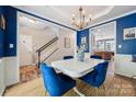 Dining area with adjacent staircase features blue walls and view into kitchen at 108 N Arcadian Way, Mooresville, NC 28117