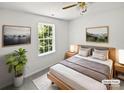 Bright staged bedroom with modern decor, a comfortable bed, and ample natural light from a large window at 1184 Lempster Nw Dr, Concord, NC 28027