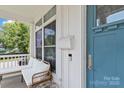 Cozy front porch featuring comfortable seating and a charming blue front door at 1201 Pegram St, Charlotte, NC 28205