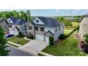 Charming two-story home with a brick facade, two-car garage, and landscaped yard at 1281 Arges River Dr, Fort Mill, SC 29715