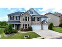 Charming two-story home with a brick facade, two-car garage, and well-manicured lawn at 1281 Arges River Dr, Fort Mill, SC 29715