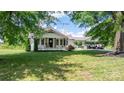 A charming home with a well-manicured lawn and a convenient carport, perfect for outdoor living at 1300 Nc 90 W Hwy, Taylorsville, NC 28681