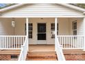 Inviting front porch with white railings, brick accents, and a screen door, enhancing the home's curb appeal at 1370 Poole Rd, Salisbury, NC 28146