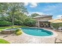 Inviting backyard oasis with a large pool, spa, and ample patio space for entertaining at 14701 Jockeys Ridge Dr, Charlotte, NC 28277