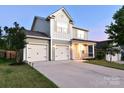 Lovely home with a spacious driveway leading to a two-car garage, set against a serene dusk backdrop at 161 Old Harbor Dr, Mount Gilead, NC 27306