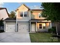 Inviting two-story home with a two-car garage, complemented by a well-maintained lawn and charming curb appeal at 161 Old Harbor Dr, Mount Gilead, NC 27306