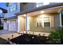 Inviting front porch adorned with charming American flags and landscape lighting for a warm welcome at 161 Old Harbor Dr, Mount Gilead, NC 27306